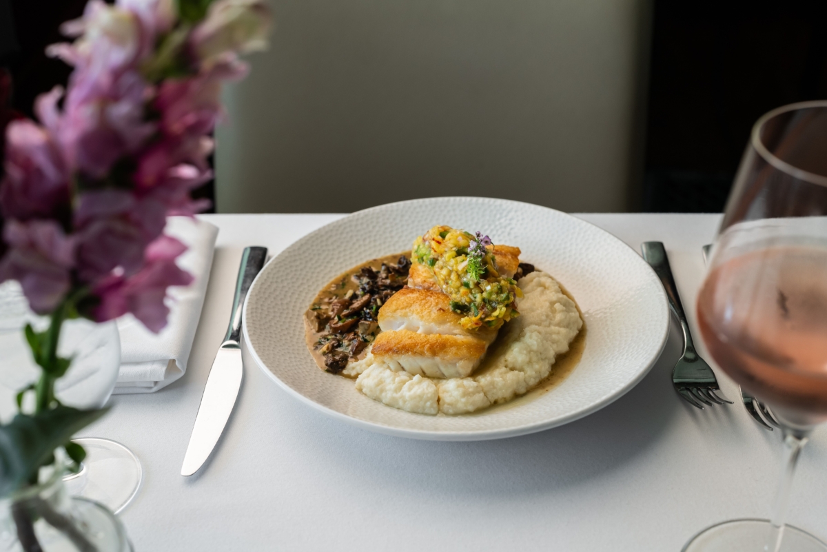 A seafood dish at a fine dining, white tablecloth place setting